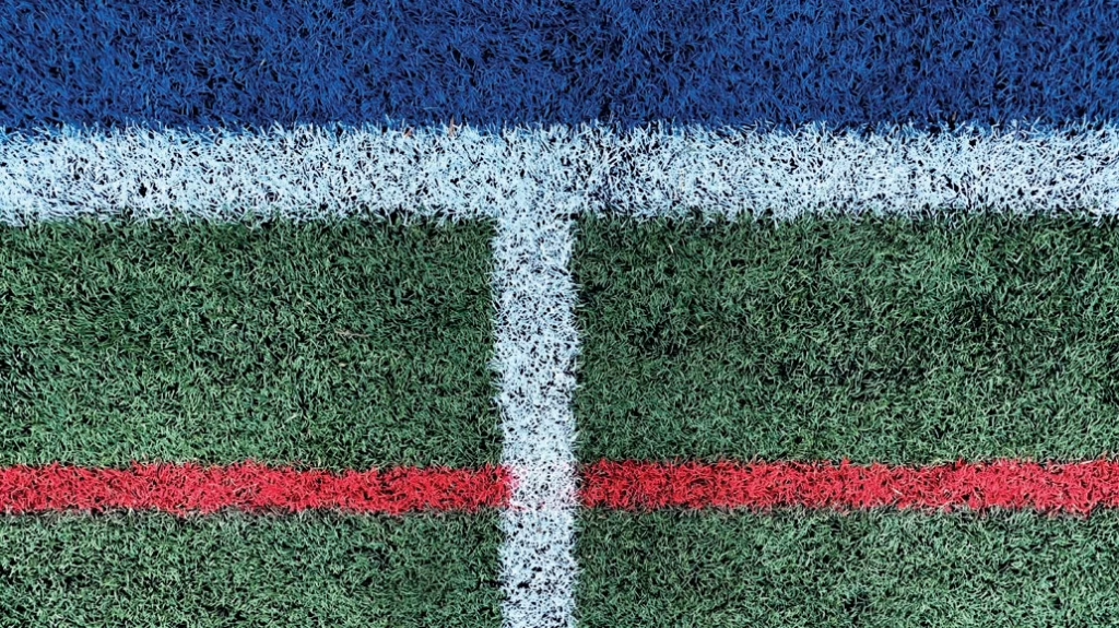 3G football pitch close up shot with white blue and red stripes
